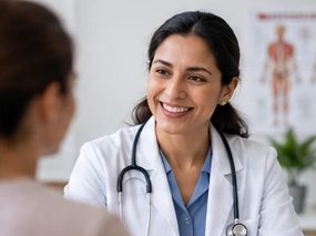 A doctor in a white coat talking with a patient